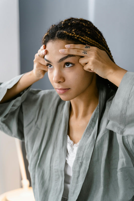 a women holding her head looking to need a skin collagen boost 